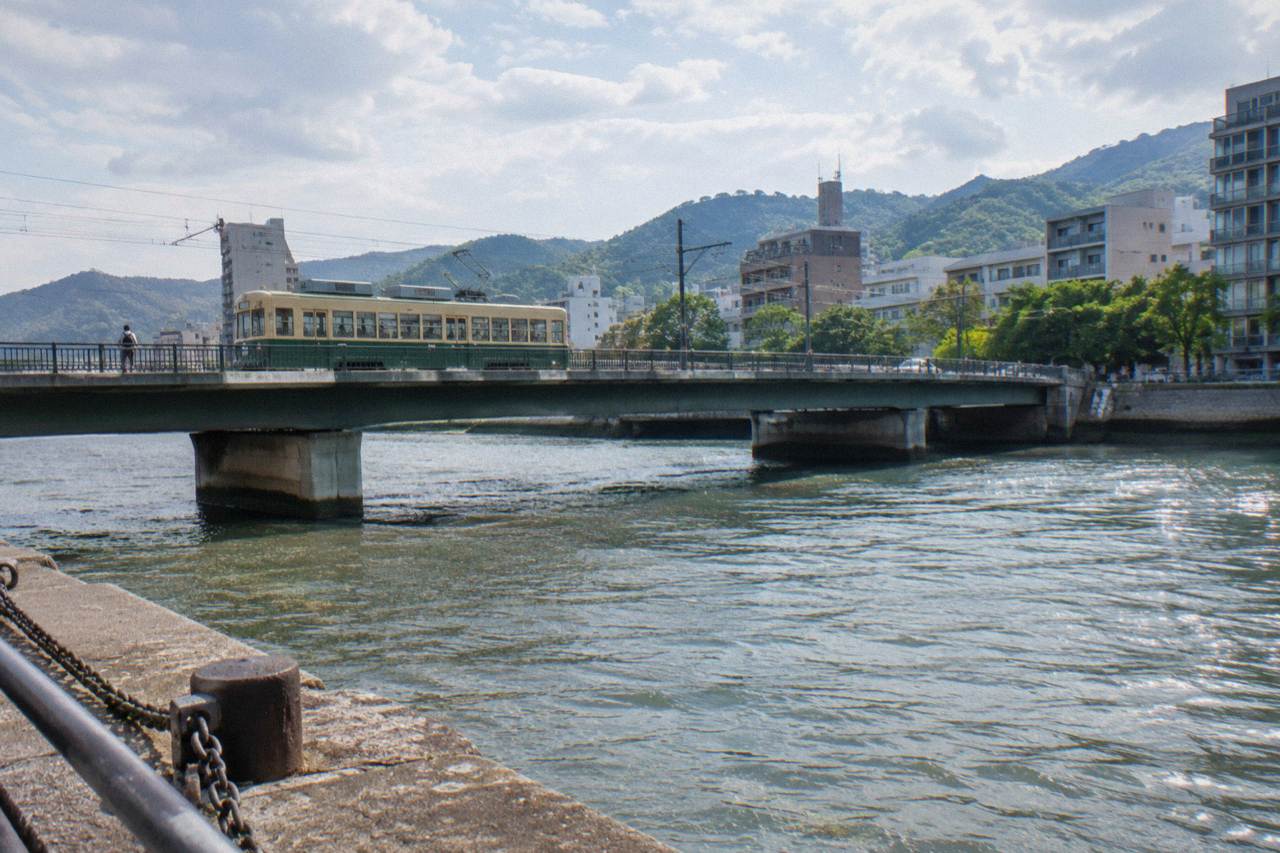 A Hiroden streetcar crossing a bridge over a river in central Hiroshima