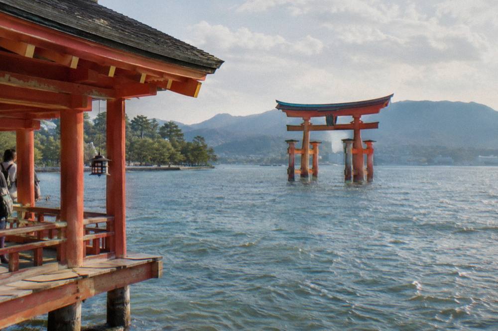 The Great Torii of Itsukushima Shrine standing in the shallow water at Miyajima