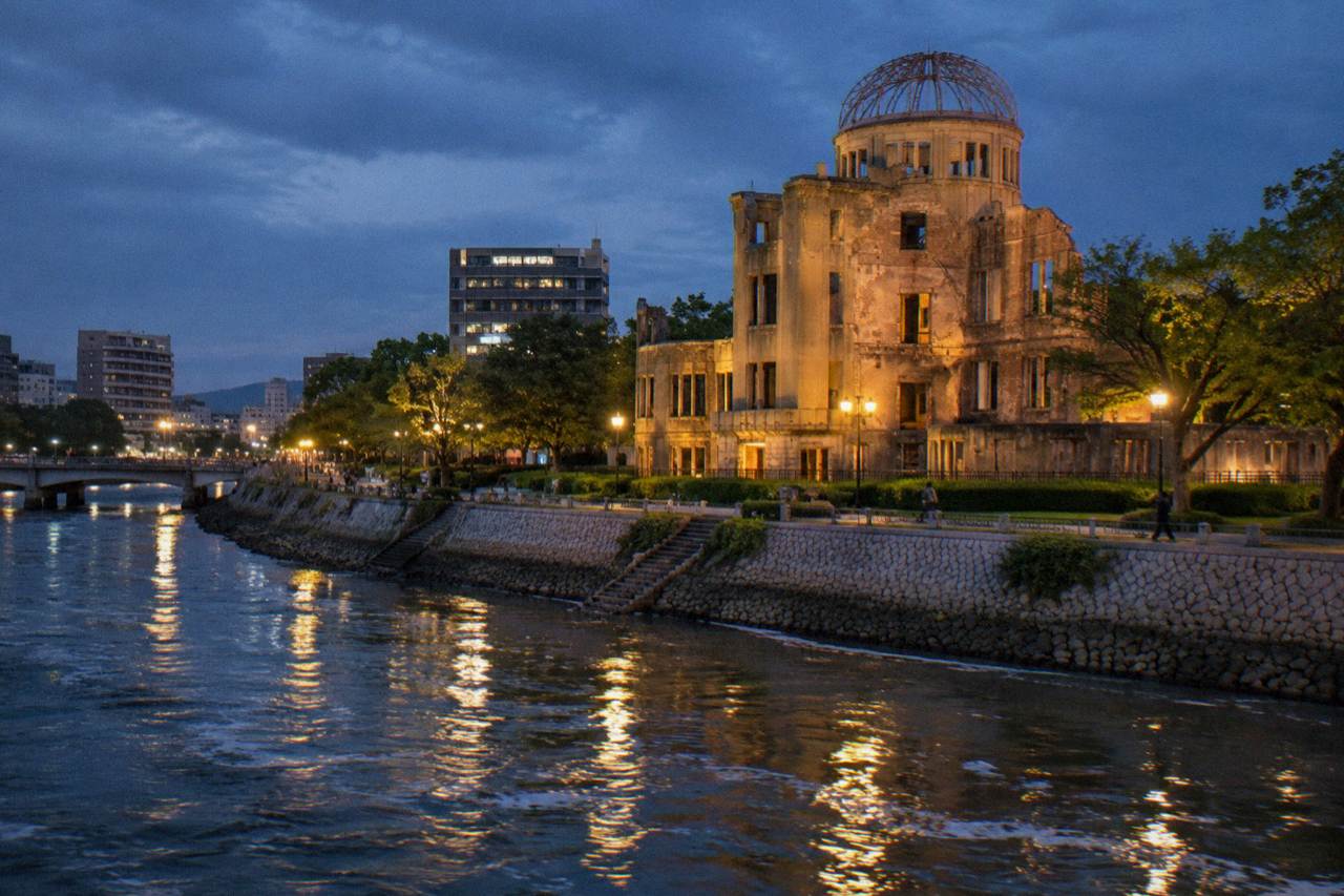 The Atomic Bomb Dome in Hiroshima standing beside the Motoyasu River at dusk