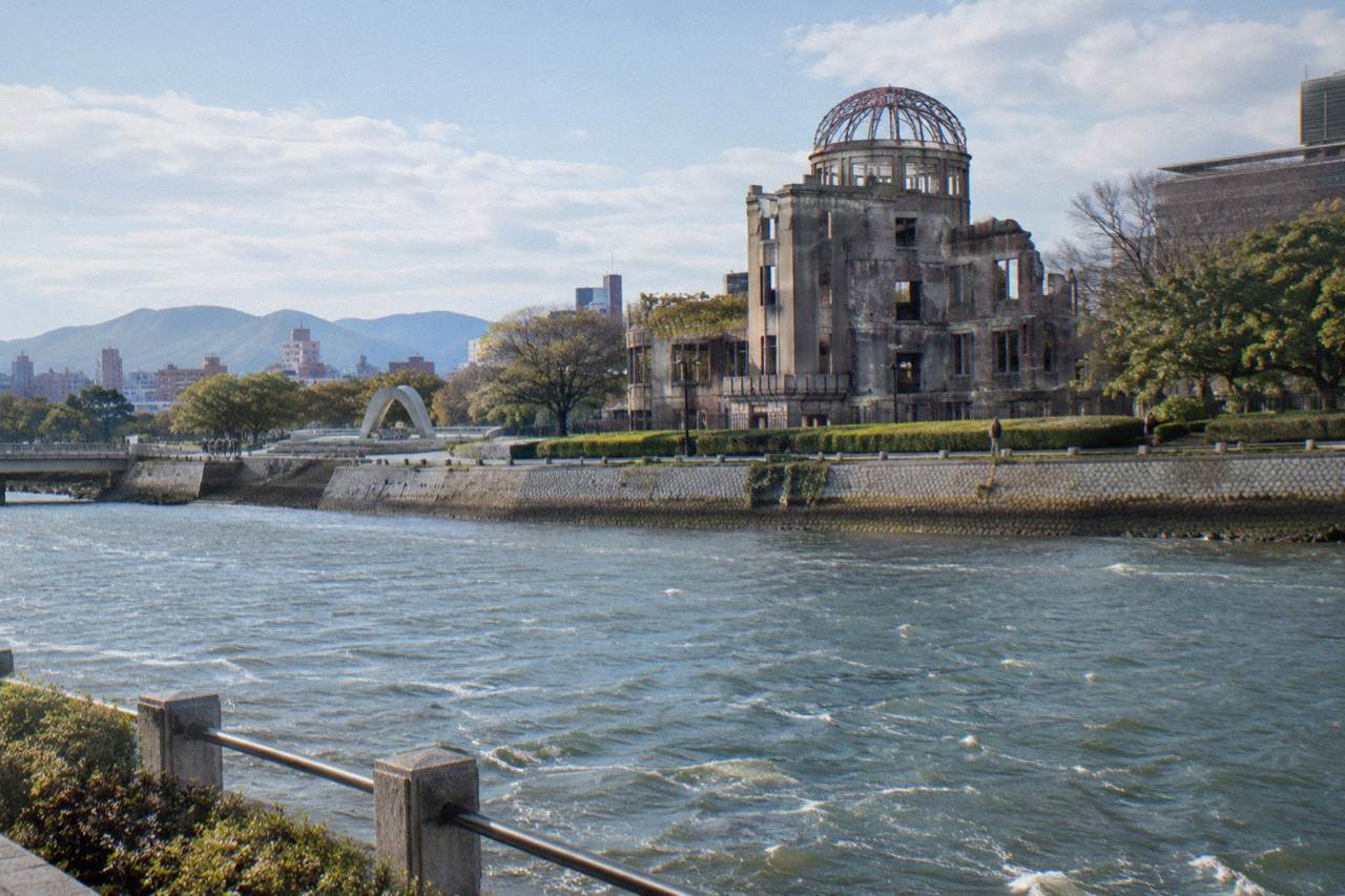 The Peace Memorial Park in Hiroshima with the Cenotaph framing the A-Bomb Dome across the river