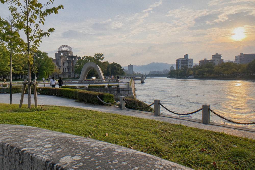 The Peace Memorial Park in Hiroshima with the Cenotaph and green lawns along the river