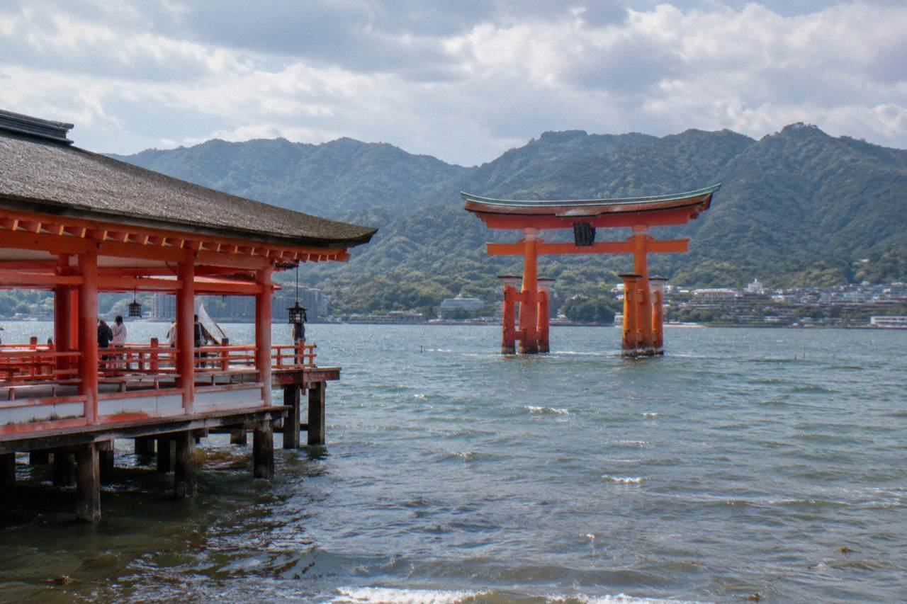 The red Great Torii gate of Itsukushima Shrine standing in shallow water on Miyajima island