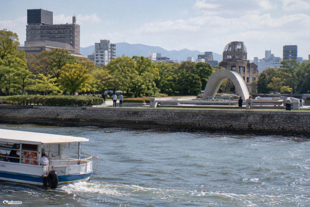 The Peace Memorial Park cenotaph in Hiroshima, with the arch of the memorial stone chamber seen across the water
