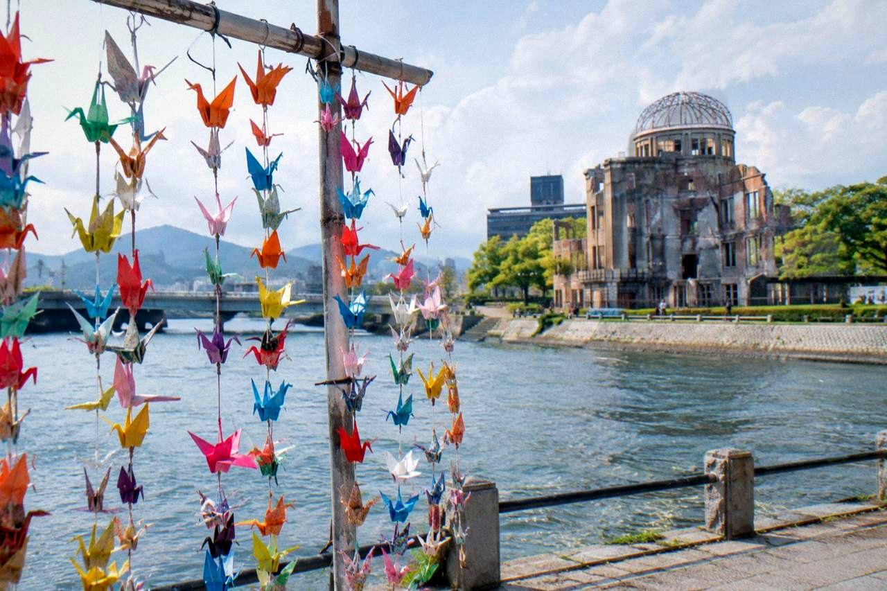 Colorful paper origami cranes strung in lines at a memorial display in Hiroshima