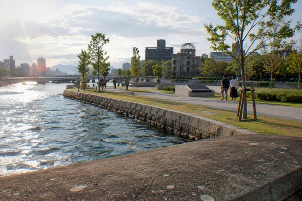 Visitors walking quietly along the paths of the Peace Memorial Park in Hiroshima