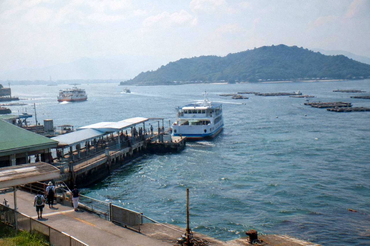 Ferry pier at Miyajimaguchi with boats waiting to cross the water to Miyajima