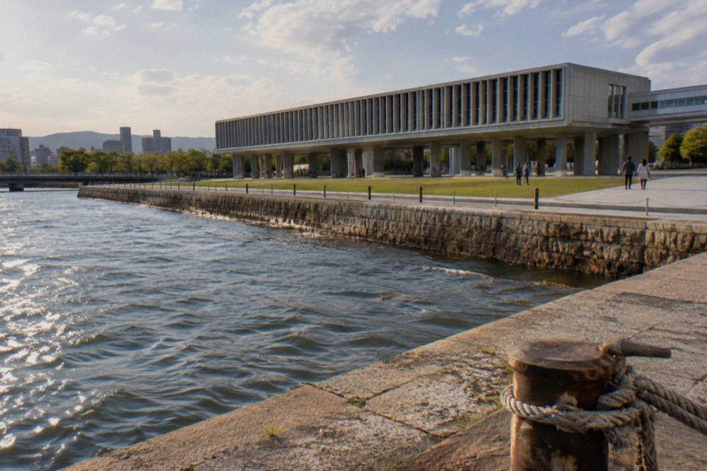 A dimly lit museum gallery with timeline panels and display cases along the wall
