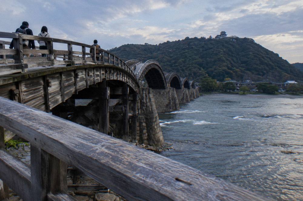 Close view of the wooden arch structure and railings of the Kintaikyo Bridge