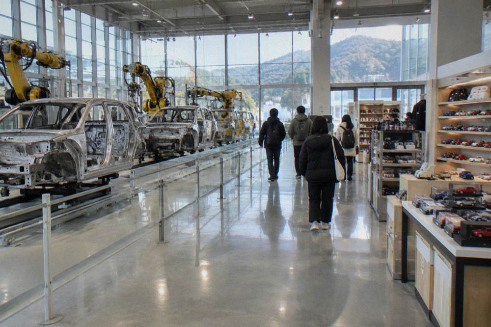 A bright museum shop interior with shelves of model cars and branded souvenirs