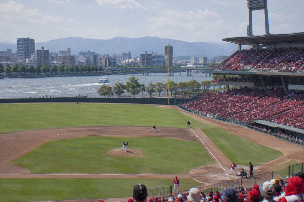 Close view of a baseball field from the stands with green grass and dirt infield