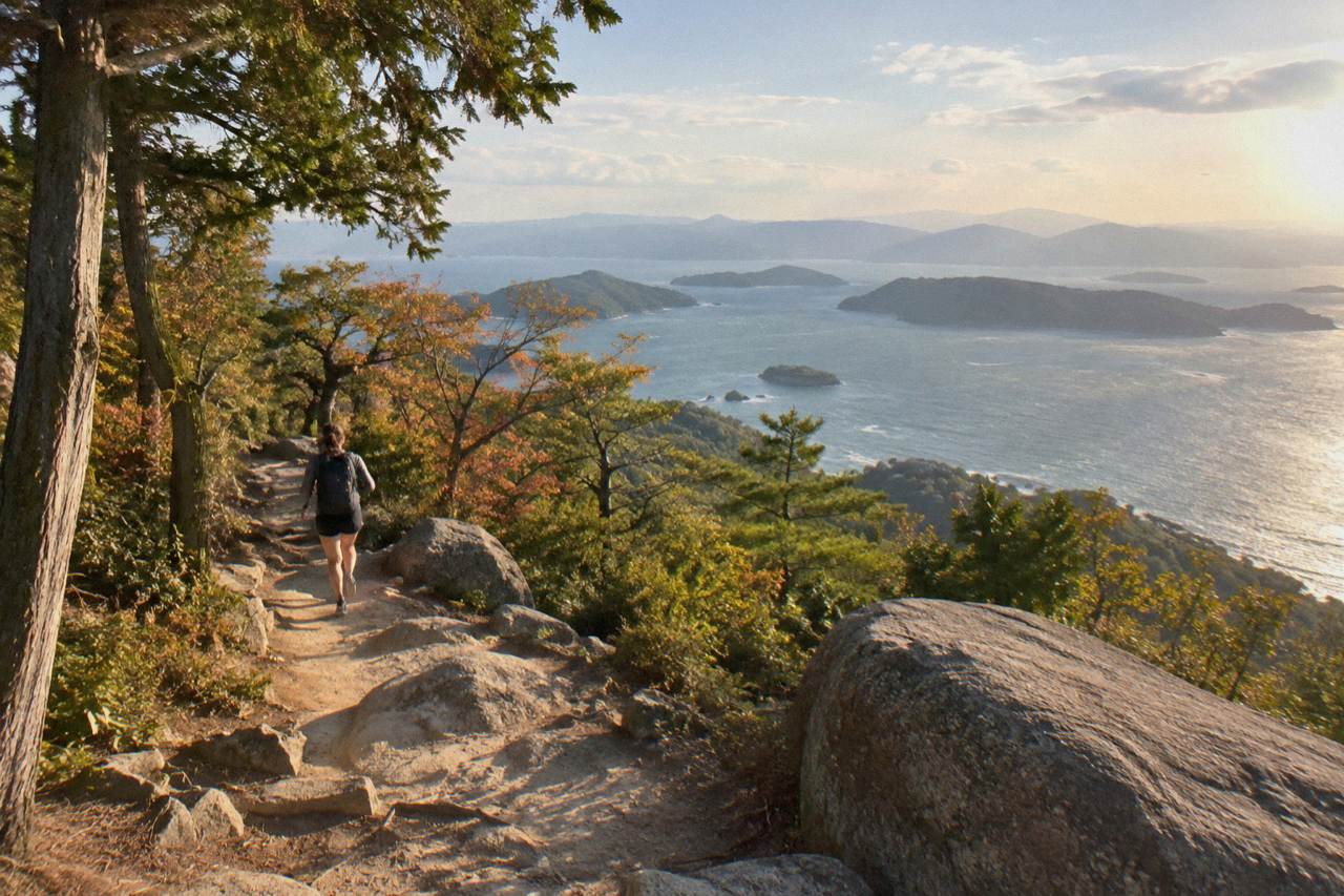 Wooded mountain ridge rising above the Seto Inland Sea with small islands in the distance