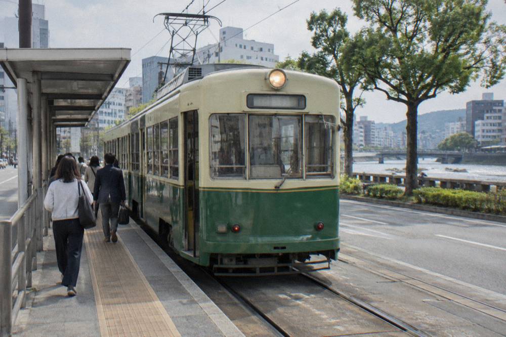 A Hiroden tram passing along a central Hiroshima street near the Hacchobori district