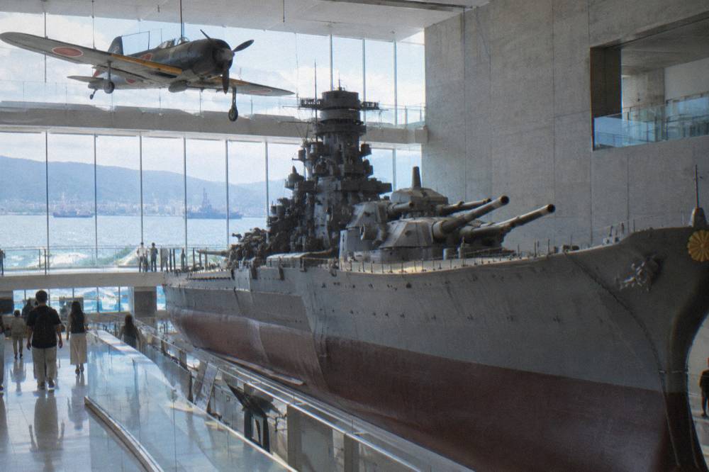 A preserved vintage fighter aircraft suspended in a museum