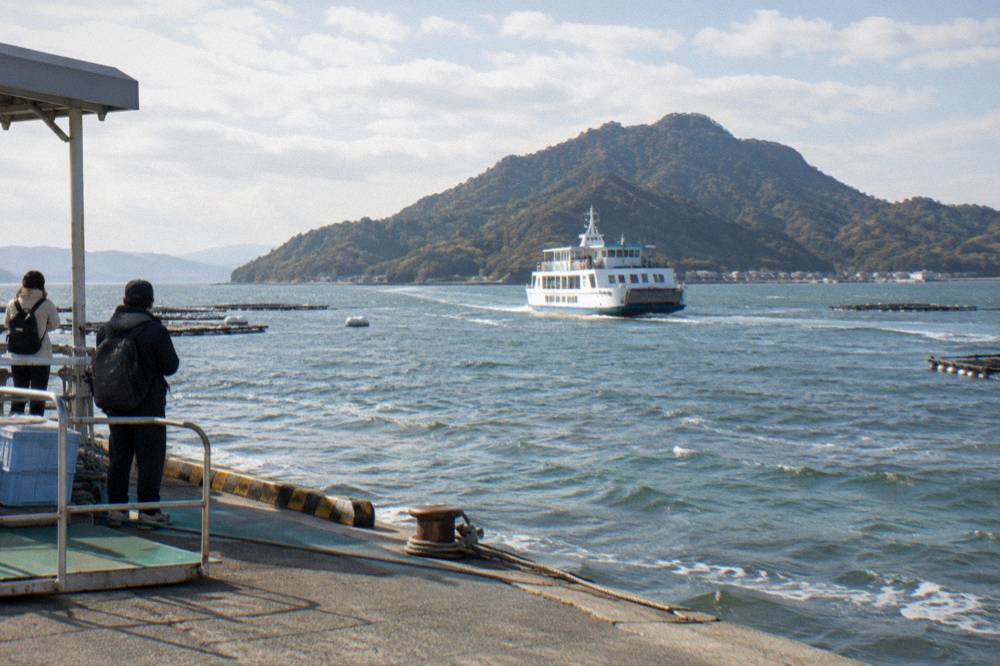 A ferry crossing the water between Miyajimaguchi and Miyajima island