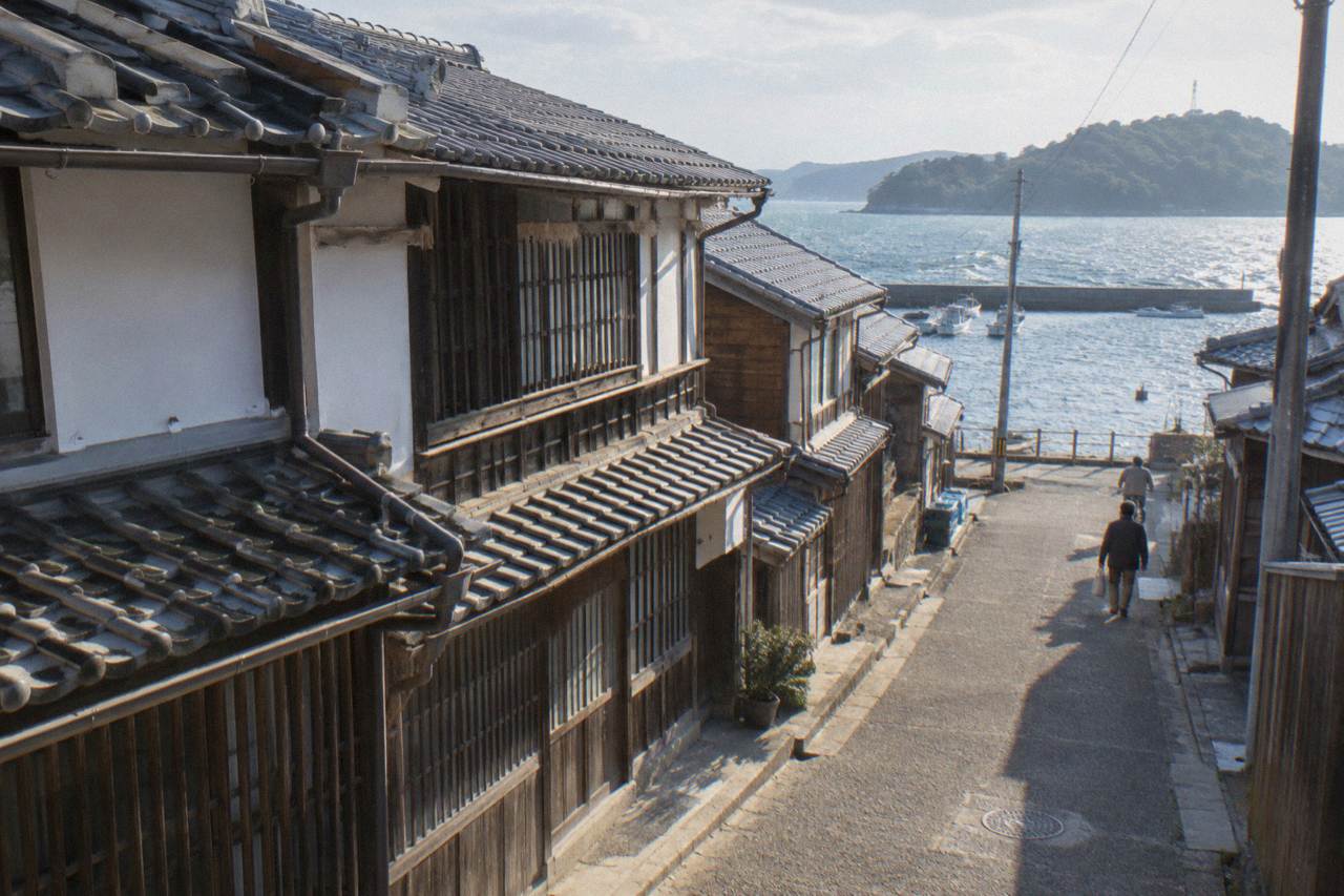 A quiet street of wooden merchant houses in a preserved Japanese townscape
