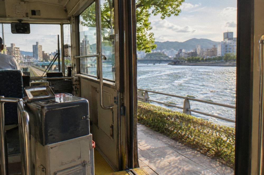 A tram interior fare box near the door of a Hiroden streetcar