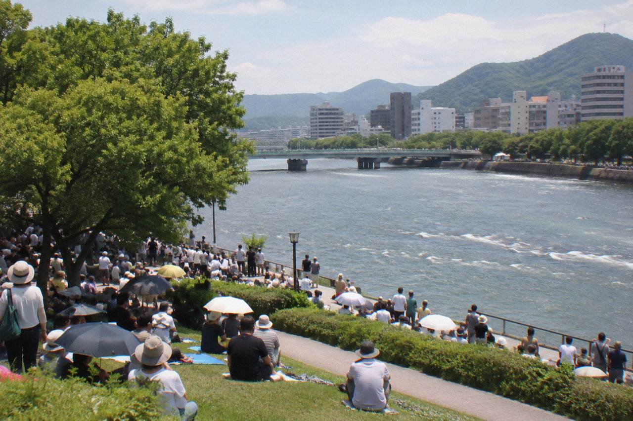 Crowds gathered at dawn in a riverside park in Hiroshima before the annual peace memorial ceremony