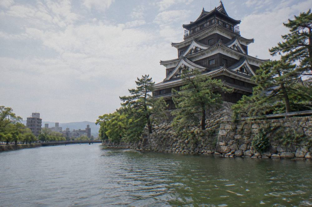 Reconstructed Hiroshima Castle keep rising above its moat and stone walls
