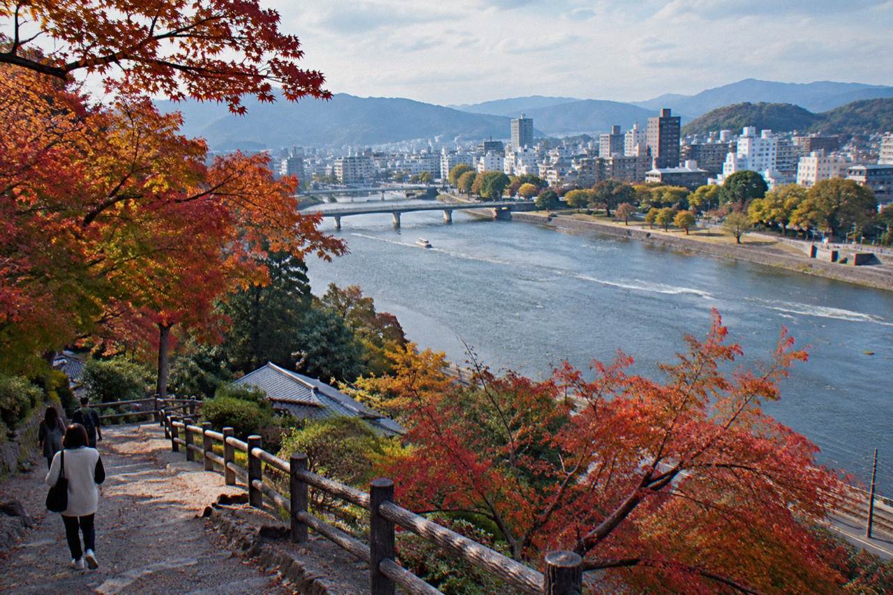 Maple trees with red and orange leaves along a garden path in Hiroshima