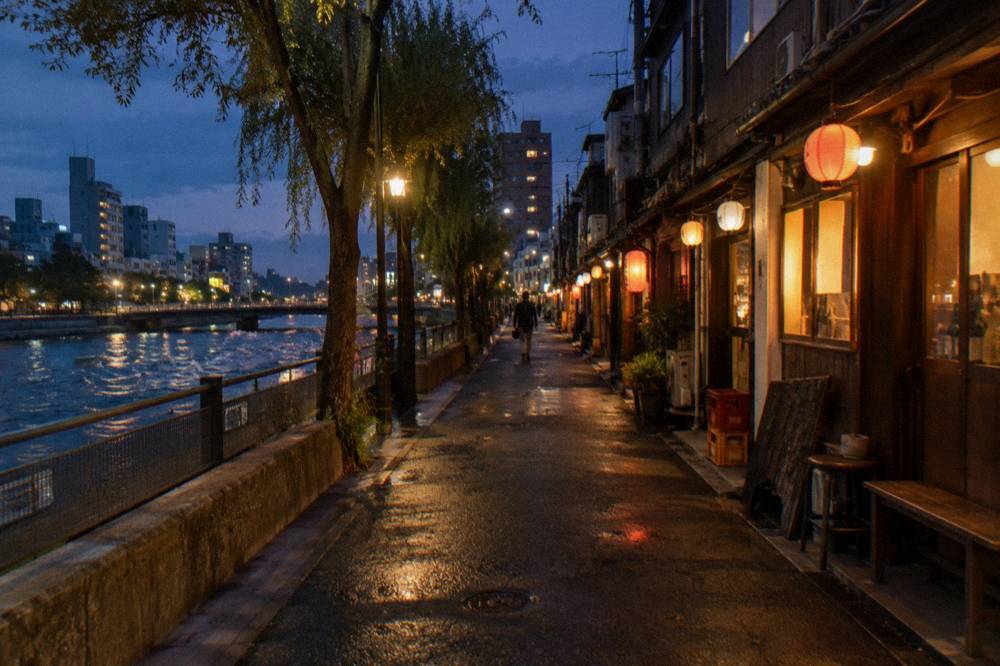 A narrow lane of small bars with paper lanterns