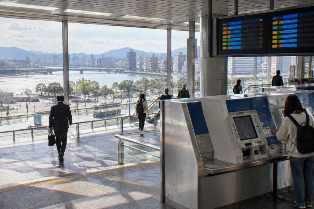A Shinkansen ticket machine and fare display inside a JR station in Japan