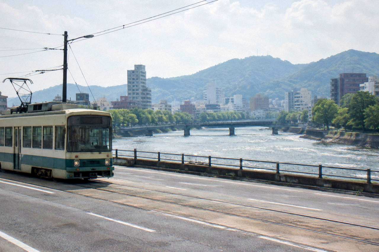 Hiroden streetcar travelling along a city street in central Hiroshima