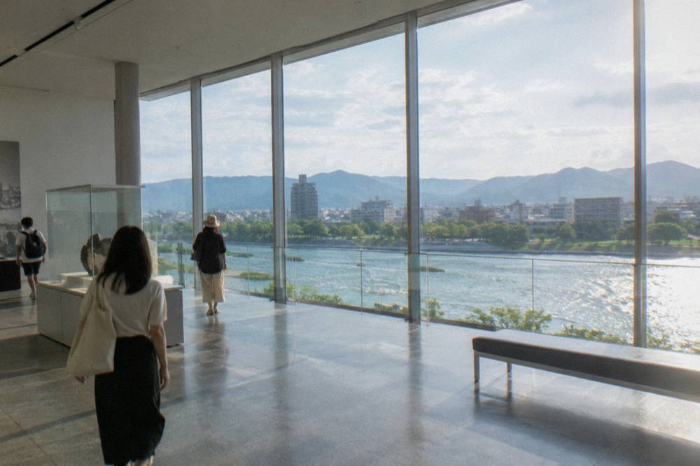 Visitors walking quietly through a bright modern museum