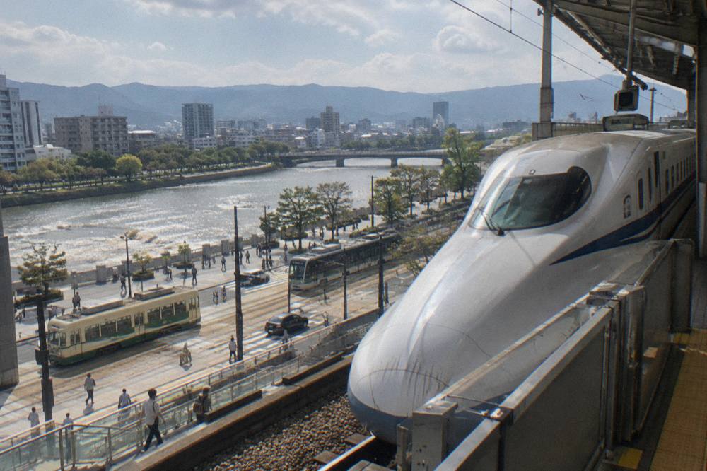 A Sanyo Shinkansen bullet train stopped at a station platform in western Japan