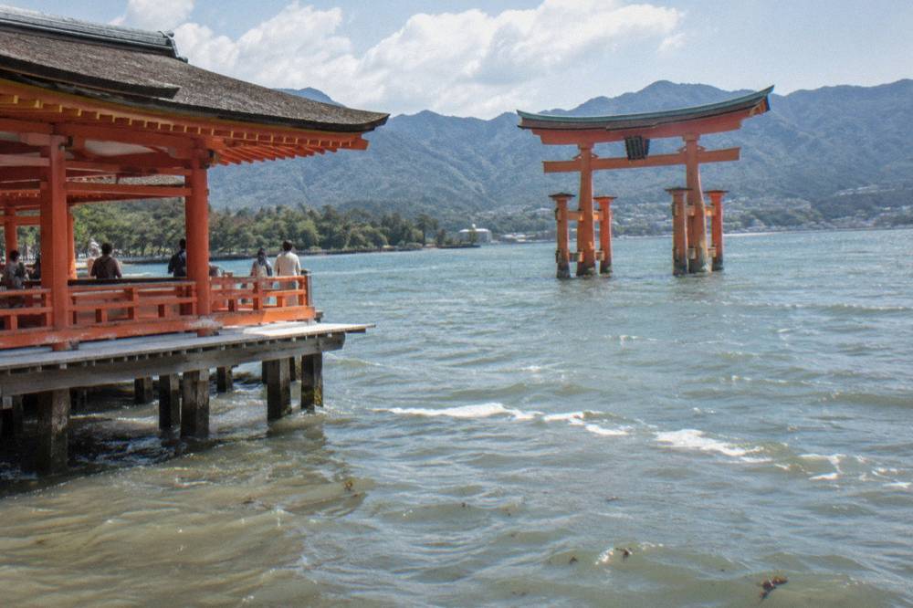 The great torii gate of Itsukushima Shrine standing in the shallows of Hiroshima Bay