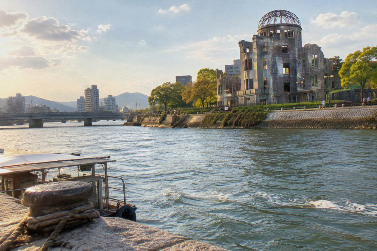 The A-Bomb Dome standing beside the Motoyasu River in Hiroshima on a clear day