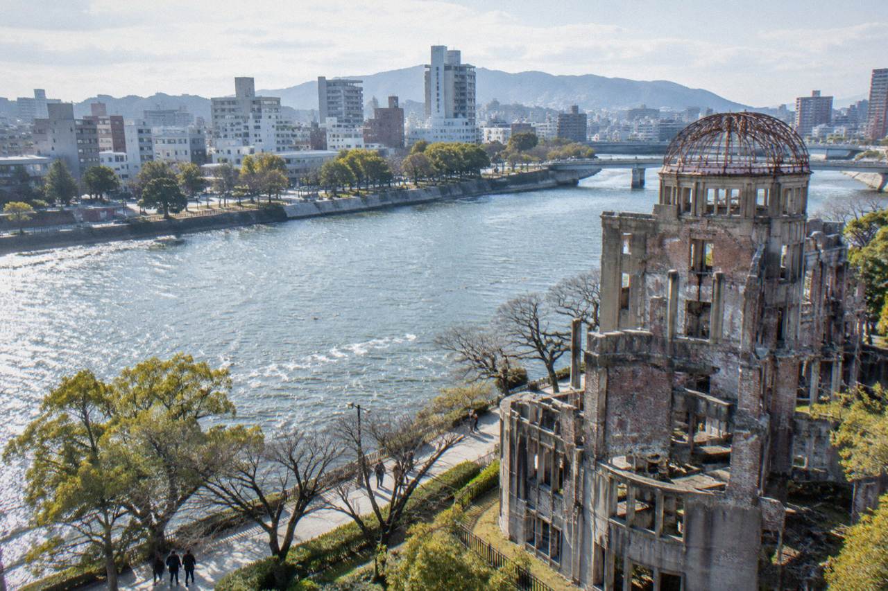 Hiroshima city skyline seen across the Motoyasu River with the Atomic Bomb Dome in the foreground