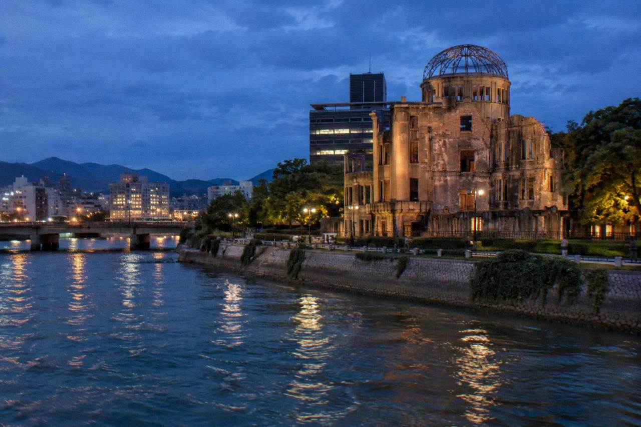 The A-Bomb Dome standing beside the Motoyasu River in Hiroshima at dusk
