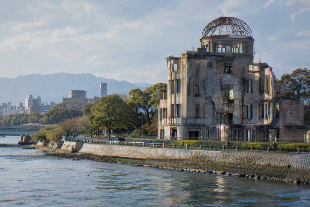 Closer view of the floodlit Atomic Bomb Dome framework against a dark sky in Hiroshima