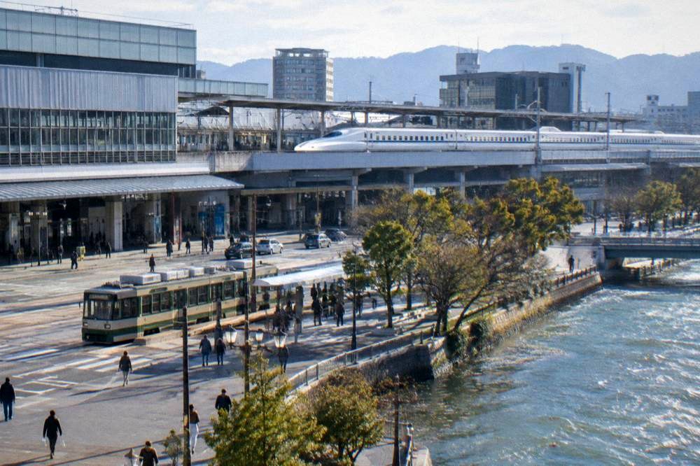 A Nozomi Shinkansen train standing at a station platform in western Japan
