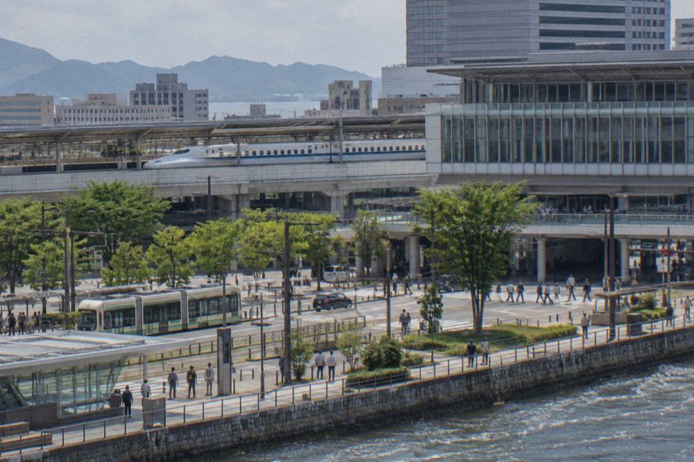 A Nozomi Shinkansen train standing at a station platform
