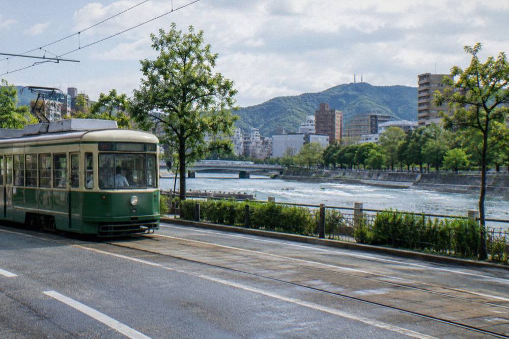A Hiroden streetcar moving along a Hiroshima street