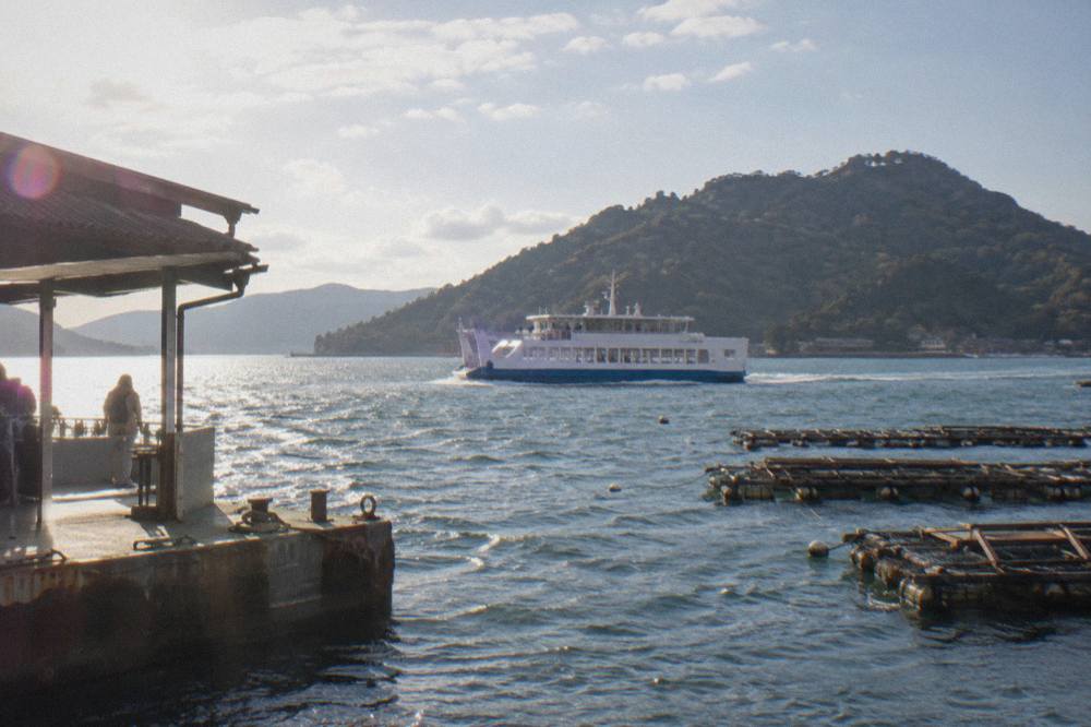 A JR ferry crossing the water between Miyajimaguchi and Miyajima island