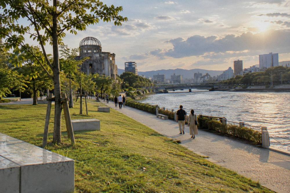 Visitors walking quietly along the paths of the Peace Memorial Park in Hiroshima