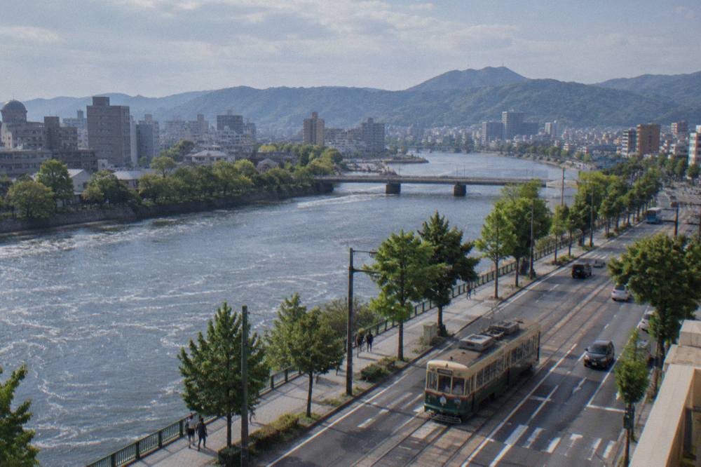 The Hiroden streetcar carrying passengers along a central Hiroshima street
